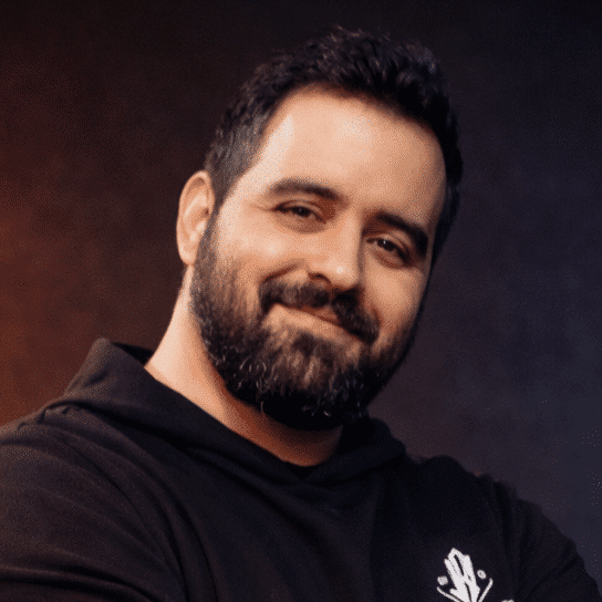Portrait of a smiling bearded man in a black hoodie