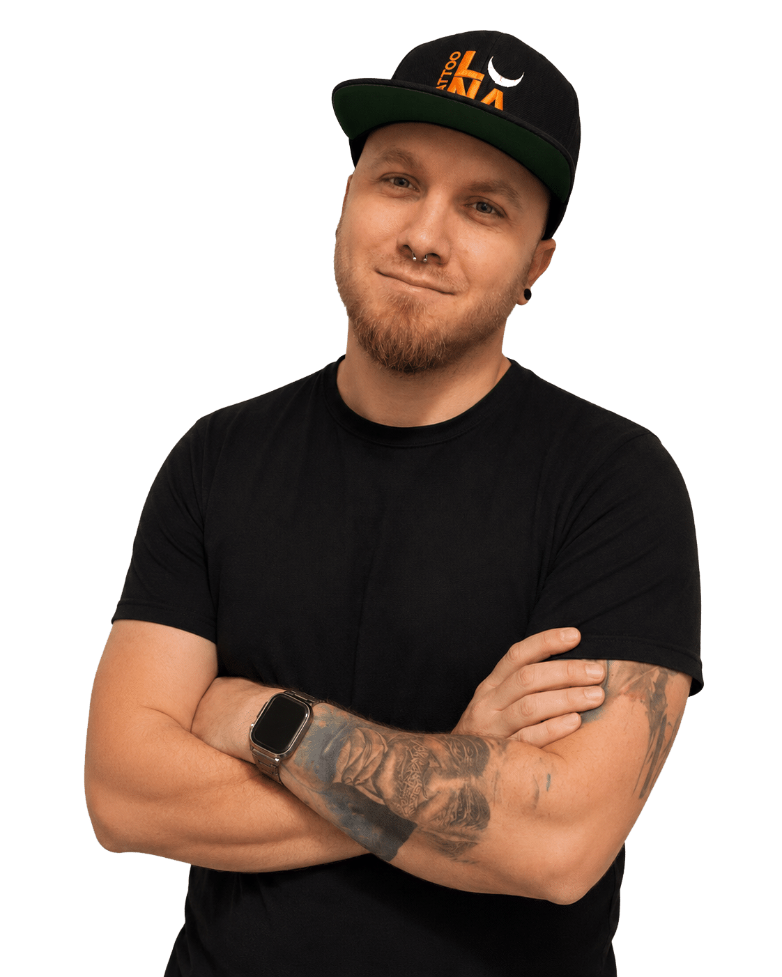 Man in a black T-shirt and cap with arms crossed, smiling at the camera