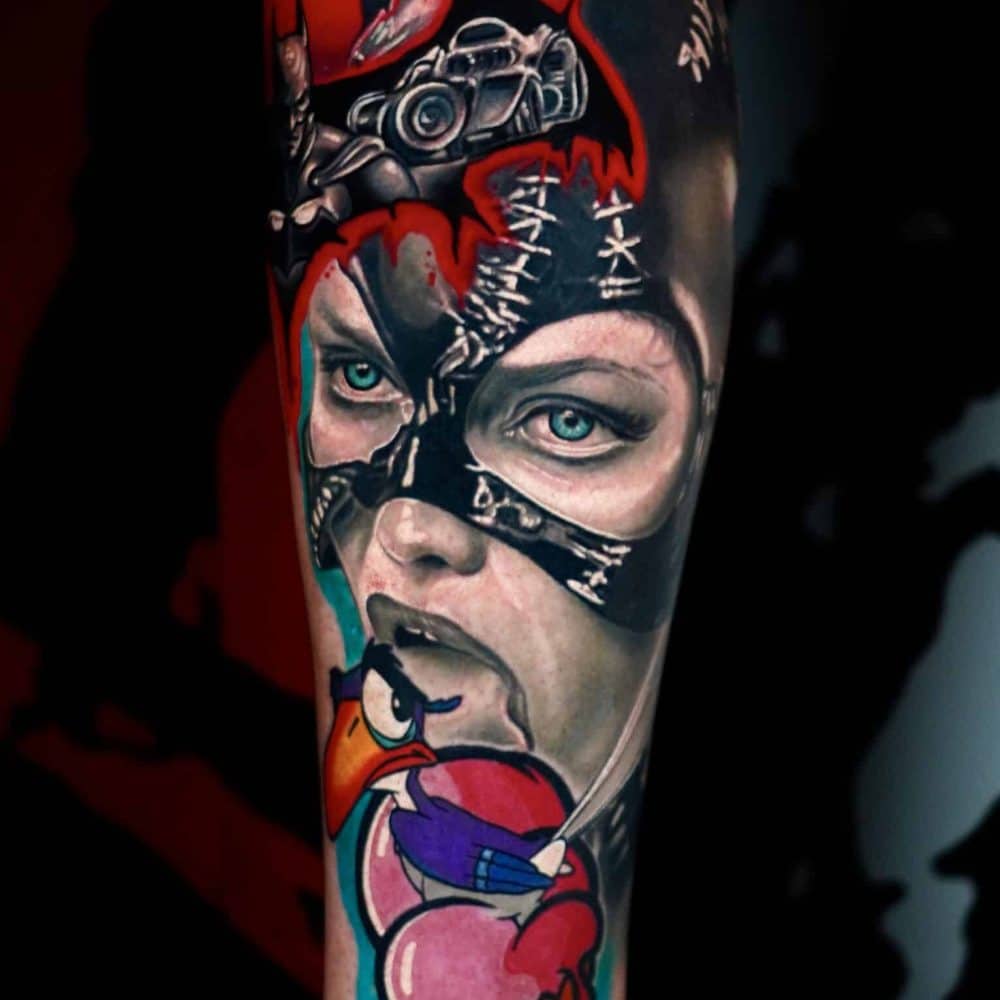 Leg tattoo featuring Catwoman’s masked face, a camera, red skyline, and a melting ice cream cone with a cartoon bird